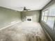 Spacious living room with a fireplace and natural light from the window at 817 Timber Creek Dr, Indianapolis, IN 46239
