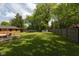 Large, well-maintained backyard with lush green grass, a shed and a trampoline at 8415 Los Robles Rd, Fishers, IN 46038