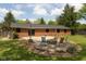 Backyard featuring a brick home, concrete patio with a fire pit, and chairs for relaxing at 8415 Los Robles Rd, Fishers, IN 46038