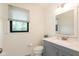 Well-lit bathroom featuring a modern vanity, white countertop, and a framed mirror at 8415 Los Robles Rd, Fishers, IN 46038