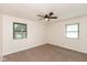 Neutral bedroom with carpet flooring, a ceiling fan, and windows with natural light at 8415 Los Robles Rd, Fishers, IN 46038