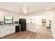 Cozy kitchen with white cabinets, black appliances, and an open view into the dining area at 8415 Los Robles Rd, Fishers, IN 46038
