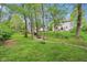 Spacious backyard with a fire pit and mature trees, offering a private outdoor retreat at 8745 Providence Dr, Fishers, IN 46038
