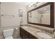 Bathroom features a double sink vanity with granite countertop and a framed mirror at 8745 Providence Dr, Fishers, IN 46038