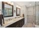Nicely appointed bathroom with double sinks, vanity, and walk-in shower at 8745 Providence Dr, Fishers, IN 46038