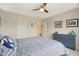 Cozy bedroom featuring a ceiling fan, a comfortable bed, and a blue dresser for ample storage at 8745 Providence Dr, Fishers, IN 46038