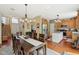 View of the dining room leading to the kitchen with island and stainless steel appliances at 8745 Providence Dr, Fishers, IN 46038