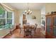 A dining room with a round wood table, chandelier, and a view into the kitchen at 8745 Providence Dr, Fishers, IN 46038