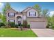 Charming two-story home with a well-manicured lawn, beautiful landscaping, and a two-car garage at 8745 Providence Dr, Fishers, IN 46038
