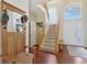 Welcoming foyer featuring wood floors, a staircase and a coat rack with seating at 8745 Providence Dr, Fishers, IN 46038