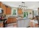 Well-lit kitchen featuring wooden cabinets, granite countertops, and an island with pendant lighting at 8745 Providence Dr, Fishers, IN 46038
