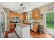 Bright kitchen with wood cabinets, granite counters, island, and modern appliances at 8745 Providence Dr, Fishers, IN 46038