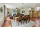 Spacious living room with fireplace, hardwood floors, dining table, and neutral color scheme at 8745 Providence Dr, Fishers, IN 46038
