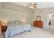 Spacious main bedroom offers a ceiling fan, plush carpet and generous natural light at 8745 Providence Dr, Fishers, IN 46038