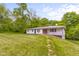 Ranch home with an open yard, surrounded by mature trees at 9170 W Old Nashville Rd, Columbus, IN 47201