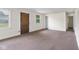 Living room with carpeted floors, door, and windows at 9170 W Old Nashville Rd, Columbus, IN 47201