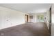 Open-concept living area with carpet floors, neutral walls, and patio access at 9170 W Old Nashville Rd, Columbus, IN 47201