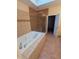 Bright bathroom featuring a large soaking tub, a glass shower, and neutral tile at 9640 Bramblewood Way, Carmel, IN 46032