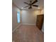 Bedroom with a window, tiled floor, ceiling fan and wooden wardrobe at 9640 Bramblewood Way, Carmel, IN 46032