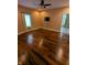 Spacious bedroom featuring hardwood floors, a ceiling fan, and bright window at 9640 Bramblewood Way, Carmel, IN 46032