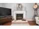 A fireplace with decorative mantel, tile work, and hearth featuring decor and accessories at 9915 Wellsford Cir, Indianapolis, IN 46236