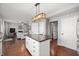 Spacious kitchen with a large island, granite countertops, stainless appliances, and hardwood floors at 9915 Wellsford Cir, Indianapolis, IN 46236