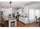 Modern kitchen with white cabinets, stainless steel appliances, and a breakfast bar at 9915 Wellsford Cir, Indianapolis, IN 46236