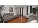 Inviting living room with hardwood floors, neutral paint, and a staircase at 9915 Wellsford Cir, Indianapolis, IN 46236