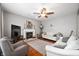 Comfortable living room featuring a cozy fireplace and neutral-toned decor at 9915 Wellsford Cir, Indianapolis, IN 46236