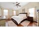 Spacious main bedroom with hardwood floors, ceiling fan, and comfortable furnishings at 9915 Wellsford Cir, Indianapolis, IN 46236