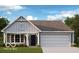 Charming single-story home with a 2-car garage and inviting front porch at 1018 Cyprian Way, Lebanon, IN 46052