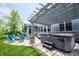 Backyard with a pergola, hot tub, a fire pit, and blue Adirondack chairs on a brick patio at 10291 Normandy Way, Fishers, IN 46040