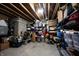 Unfinished basement with exposed ceiling, concrete floor, and storage shelves filled with various items at 10291 Normandy Way, Fishers, IN 46040