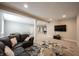 Spacious basement featuring neutral carpet, a dark leather couch, and plenty of room for entertaining at 10291 Normandy Way, Fishers, IN 46040
