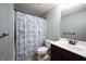 Bathroom featuring a blue and white patterned shower curtain, a toilet, and a vanity sink at 10291 Normandy Way, Fishers, IN 46040