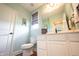 Powder room with sleek vanity, toilet, framed mirror, and window at 10291 Normandy Way, Fishers, IN 46040