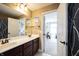 Bathroom with double sinks, dark wood cabinets, and a shower/tub combo at 10291 Normandy Way, Fishers, IN 46040