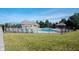 Community pool area with lounge chairs, gazebo, and a secure fence, perfect for summer relaxation at 10291 Normandy Way, Fishers, IN 46040