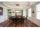 Elegant dining room features a tray ceiling, modern chandelier, and classic wood floors at 10291 Normandy Way, Fishers, IN 46040
