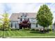 Charming two-story home with a well-maintained lawn and mature trees at 10291 Normandy Way, Fishers, IN 46040