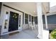 Inviting front porch with rocking chairs and stylish front door décor at 10291 Normandy Way, Fishers, IN 46040