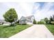 Spacious three-car garage with a long driveway and lush landscaping at 10291 Normandy Way, Fishers, IN 46040