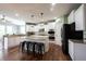 Spacious kitchen boasts white cabinets, granite counters, stainless steel appliances, and a large island with seating at 10291 Normandy Way, Fishers, IN 46040