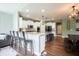 Bright, open kitchen with barstool seating, stainless appliances, and a seamless transition to the dining and living areas at 10291 Normandy Way, Fishers, IN 46040