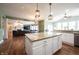 Open-concept kitchen features a large island with granite countertops and seating, connecting to the living room at 10291 Normandy Way, Fishers, IN 46040