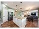 Open kitchen with island, stainless steel fridge, and view into the dining and living rooms at 10291 Normandy Way, Fishers, IN 46040