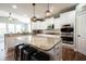 Well-lit kitchen with granite island and countertops, stainless steel appliances, and modern pendant lighting at 10291 Normandy Way, Fishers, IN 46040