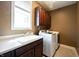 Laundry room with white washer and dryer, sink and overhead cabinets at 10291 Normandy Way, Fishers, IN 46040