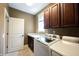 Functional laundry room with washer, dryer, sink, and ample storage cabinets at 10291 Normandy Way, Fishers, IN 46040