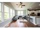 Comfortable living room with a sectional, many windows, hardwood floors, and an adjacent open-concept kitchen at 10291 Normandy Way, Fishers, IN 46040